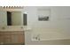 Bright bathroom offers a large soaking tub by a window and a double sink vanity at 5250 Shamus Dr, Indianapolis, IN 46235
