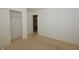 Neutral-toned bedroom with carpet, a closet, and an open doorway to another room at 5250 Shamus Dr, Indianapolis, IN 46235