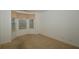 Bright bedroom featuring a bay window with blinds and neutral carpet flooring at 5250 Shamus Dr, Indianapolis, IN 46235
