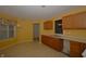 Bright kitchen featuring wood cabinetry, a double sink under a window, and a functional layout at 5250 Shamus Dr, Indianapolis, IN 46235