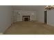 Large living room with fireplace, neutral carpet, and French doors, providing a cozy and bright atmosphere at 5250 Shamus Dr, Indianapolis, IN 46235