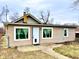 Inviting single-story home featuring a welcoming front entrance, large windows, and neutral siding at 64 S 10Th Ave, Beech Grove, IN 46107