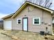 View of home's rear featuring a one car garage, neutral siding, and well-maintained exterior at 64 S 10Th Ave, Beech Grove, IN 46107