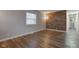 Living room featuring wood-look floors and an accent wall at 8 Crestview Dr, Greenwood, IN 46143