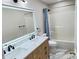 Bathroom featuring a double vanity with marble counters and modern fixtures, with a shower tub combo at 13271 Lorenzo Blvd, Carmel, IN 46074