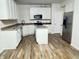 A modern kitchen featuring white cabinetry, stainless steel appliances, and a functional center island at 13271 Lorenzo Blvd, Carmel, IN 46074