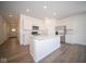 Modern kitchen with white cabinets and center island at 1390 Foxtail Ln, Greenwood, IN 46143