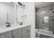 Modern bathroom with double vanity, gray cabinets, and a glass shower at 1825 N New Jersey St, Indianapolis, IN 46202