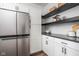 Modern pantry with white cabinets, dark countertop, and open shelving at 1825 N New Jersey St, Indianapolis, IN 46202