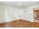 Well-lit bedroom with hardwood floors and access to hallway at 230 S Central St, Atlanta, IN 46031