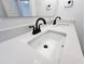 Close up of a double sink vanity with black faucets and white countertop at 537 Gilder Dr, Carmel, IN 46032