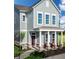 Two-story house with gray siding, a front porch, and landscaping at 537 Gilder Dr, Carmel, IN 46032