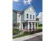 Two-story house with gray siding, a front porch, and landscaping at 537 Gilder Dr, Carmel, IN 46032