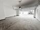 Empty two car garage with concrete flooring and a view of the neighborhood at 537 Gilder Dr, Carmel, IN 46032