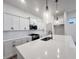Bright kitchen featuring stainless steel sink in center island, pendant lights, white cabinets, and stainless appliances at 537 Gilder Dr, Carmel, IN 46032