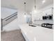Bright kitchen featuring stainless steel sink in center island, pendant lights, white cabinets, and stainless appliances at 537 Gilder Dr, Carmel, IN 46032