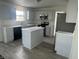 Modern kitchen features an island, stainless appliances, gray cabinets and sleek countertops at 6936 W Briarwood Blvd, New Palestine, IN 46163