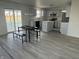 Bright kitchen features an island, stainless appliances, gray cabinets and sliding glass doors leading to backyard at 6936 W Briarwood Blvd, New Palestine, IN 46163