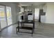 Bright kitchen features an island, stainless appliances, gray cabinets and sliding glass doors to backyard at 6936 W Briarwood Blvd, New Palestine, IN 46163