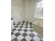 Bright laundry room with checkerboard floor, shelving, and utility hookups at 6936 W Briarwood Blvd, New Palestine, IN 46163
