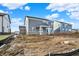 New construction backyard featuring a grey house with a covered porch, and a spacious unlandscaped yard at 20397 Hudson Bay Ln, Westfield, IN 46074