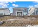 Exterior view of gray home and backyard with covered porch and sliding doors, ready for landscaping at 20397 Hudson Bay Ln, Westfield, IN 46074