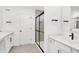 Bright bathroom featuring double sinks, a sleek shower with black trim, and modern fixtures at 20397 Hudson Bay Ln, Westfield, IN 46074