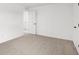 Empty bedroom featuring carpet, white walls, and baseboard trim with an open doorway at 20397 Hudson Bay Ln, Westfield, IN 46074
