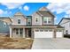 Charming two-story home featuring stone accents, a two-car garage, and a well-manicured lawn on a sunny day at 20397 Hudson Bay Ln, Westfield, IN 46074
