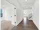 Inviting foyer showcasing beautiful hardwood floors, a staircase with black iron spindles, and a view to a sunny front room at 20397 Hudson Bay Ln, Westfield, IN 46074