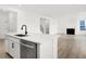Open kitchen island with stainless steel dishwasher overlooking the living room with fireplace at 20397 Hudson Bay Ln, Westfield, IN 46074