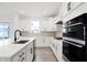 Bright kitchen featuring white cabinetry, modern appliances, and a large island with dishwasher at 20397 Hudson Bay Ln, Westfield, IN 46074