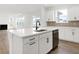 Open kitchen island with stainless steel dishwasher overlooking the living room with fireplace at 20397 Hudson Bay Ln, Westfield, IN 46074