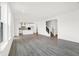 Open-concept living space connecting to a modern kitchen and showcasing the staircase with a black iron railing at 20397 Hudson Bay Ln, Westfield, IN 46074