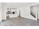 Open-concept living area leads to the modern kitchen and a staircase, creating a welcoming space at 20397 Hudson Bay Ln, Westfield, IN 46074