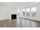 Bright living room featuring a cozy fireplace and large windows offering plenty of natural light at 20397 Hudson Bay Ln, Westfield, IN 46074