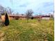 Spacious backyard featuring a well-maintained lawn and mature trees, perfect for outdoor activities at 4619 Mac Dr, Anderson, IN 46013