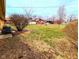 Expansive backyard featuring a well-maintained lawn, mature trees, and a storage shed at 4619 Mac Dr, Anderson, IN 46013