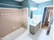 Well-lit bathroom with modern vanity, tile flooring, and shower/tub combination at 4619 Mac Dr, Anderson, IN 46013