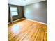 Bedroom featuring hardwood floors, neutral paint and a large window with natural light at 4619 Mac Dr, Anderson, IN 46013