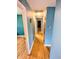 Long hallway featuring hardwood floors and multiple doorways to different rooms at 4619 Mac Dr, Anderson, IN 46013