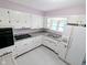 Bright kitchen featuring white cabinets, gray countertops, and modern appliances at 4619 Mac Dr, Anderson, IN 46013