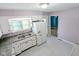 A bright eat-in kitchen is shown with white cabinets and tile flooring at 4619 Mac Dr, Anderson, IN 46013