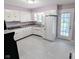 Kitchen with bright white cabinets, modern tile floors and stainless steel appliances at 4619 Mac Dr, Anderson, IN 46013