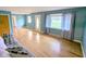 Bright living room featuring hardwood floors, large windows, and fresh paint at 4619 Mac Dr, Anderson, IN 46013