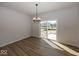 Bright dining room with a modern chandelier and sliding glass doors leading to the backyard at 4991 Elaine Ct, Noblesville, IN 46062