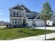 Charming two-story home with gray siding, black shutters, a manicured lawn, and a two-car garage at 4991 Elaine Ct, Noblesville, IN 46062