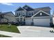 Charming two-story home with gray siding, black shutters, a manicured lawn, and a two-car garage at 4991 Elaine Ct, Noblesville, IN 46062
