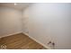 The laundry room features durable wood-look flooring and a convenient wire shelf for storage at 4991 Elaine Ct, Noblesville, IN 46062