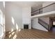 Open-concept living room with fireplace, staircase, and natural light create an inviting atmosphere at 4991 Elaine Ct, Noblesville, IN 46062